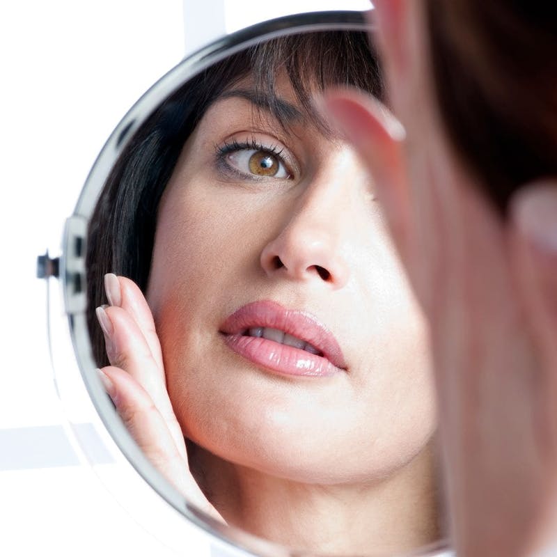 Woman Looking at Her Reflection