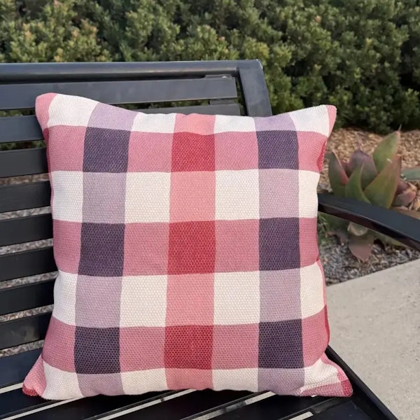 Plaid pillow on a bench