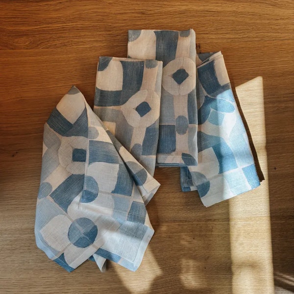 Four blue and white napkins in the sunlight