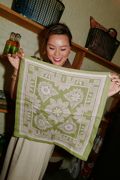Woman holding a green patterned square textile
