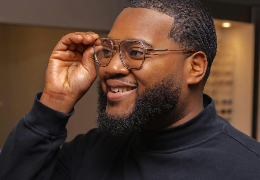 man holding his glasses