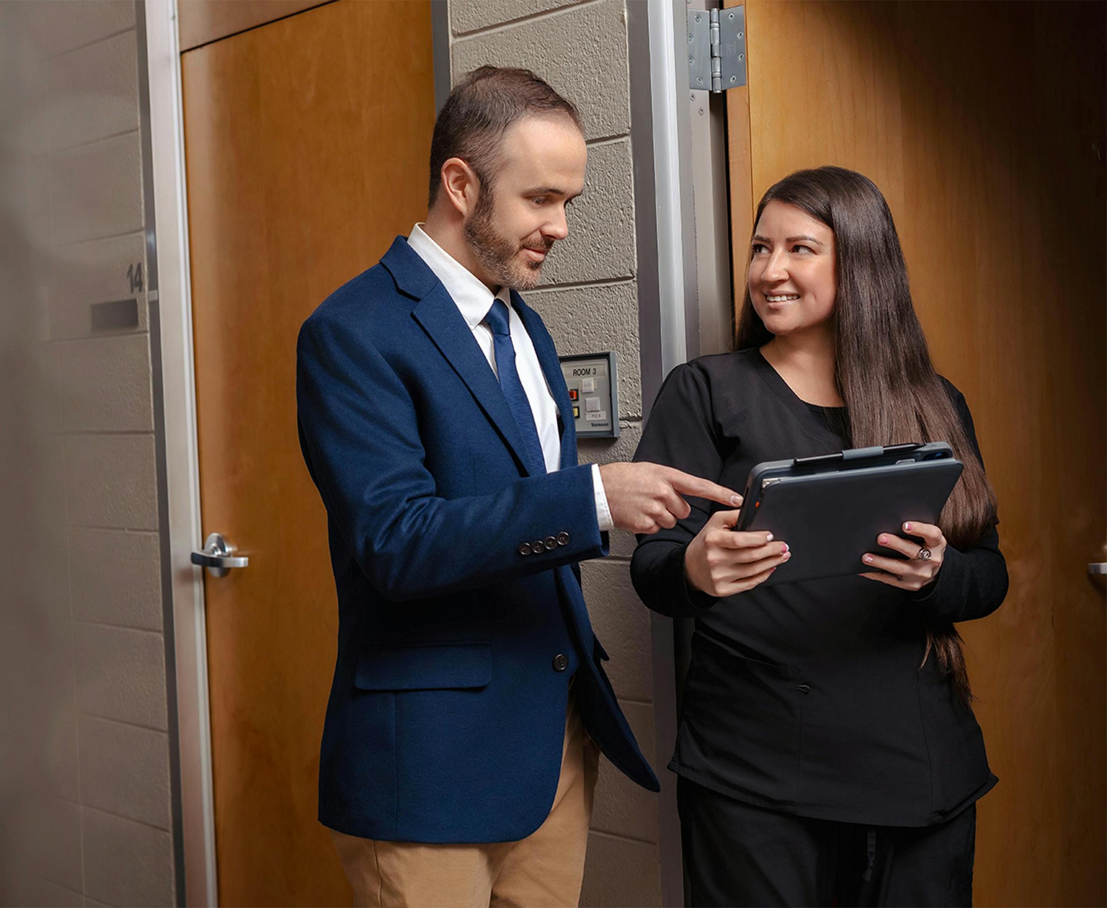 man and woman with an ipad