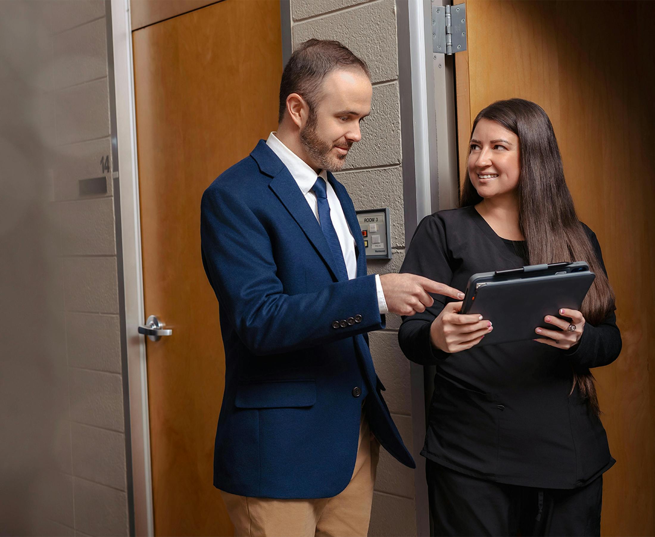 two people looking at a tablet