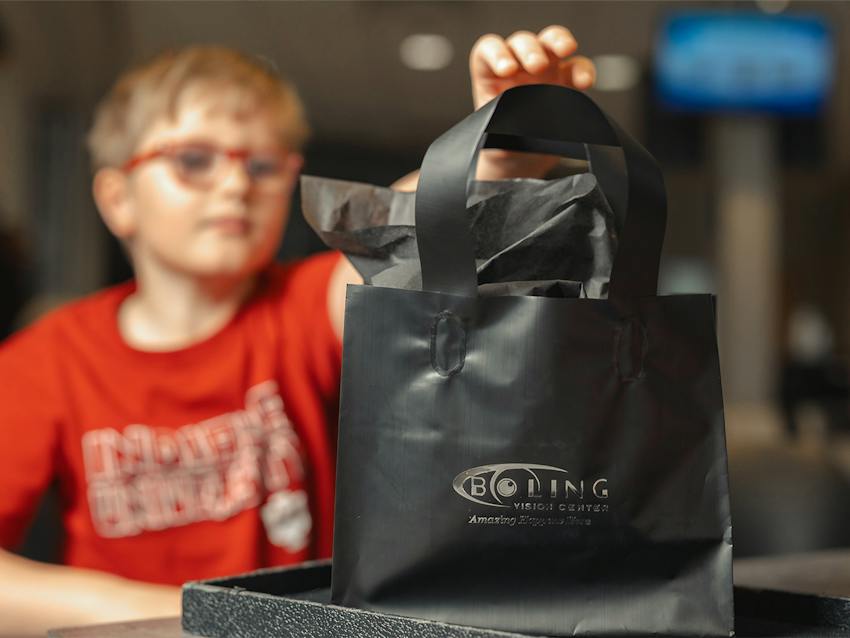 A child grabbing a bag