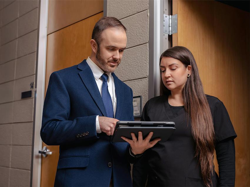two people looking at a tablet