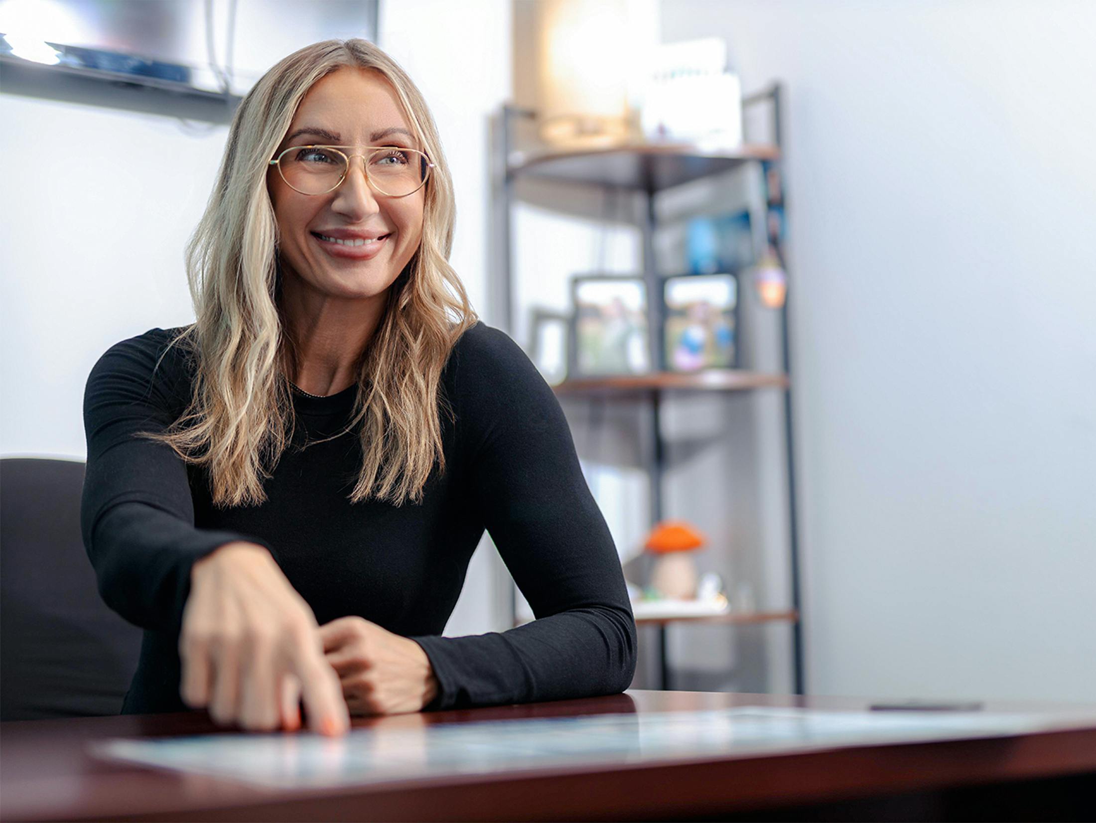 woman pointing to the desk