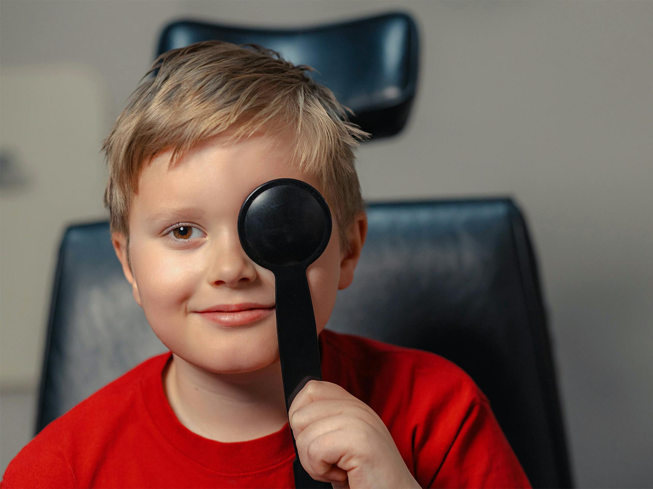 child covering one eye