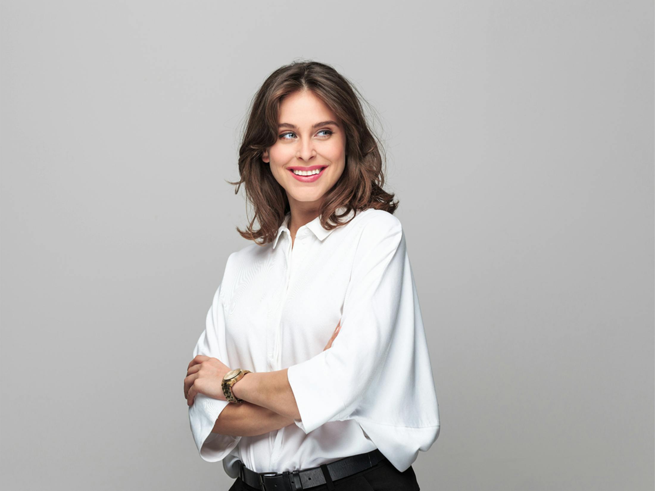 Woman smiling with her arms crossed