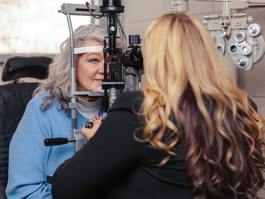 women looking into an eye test