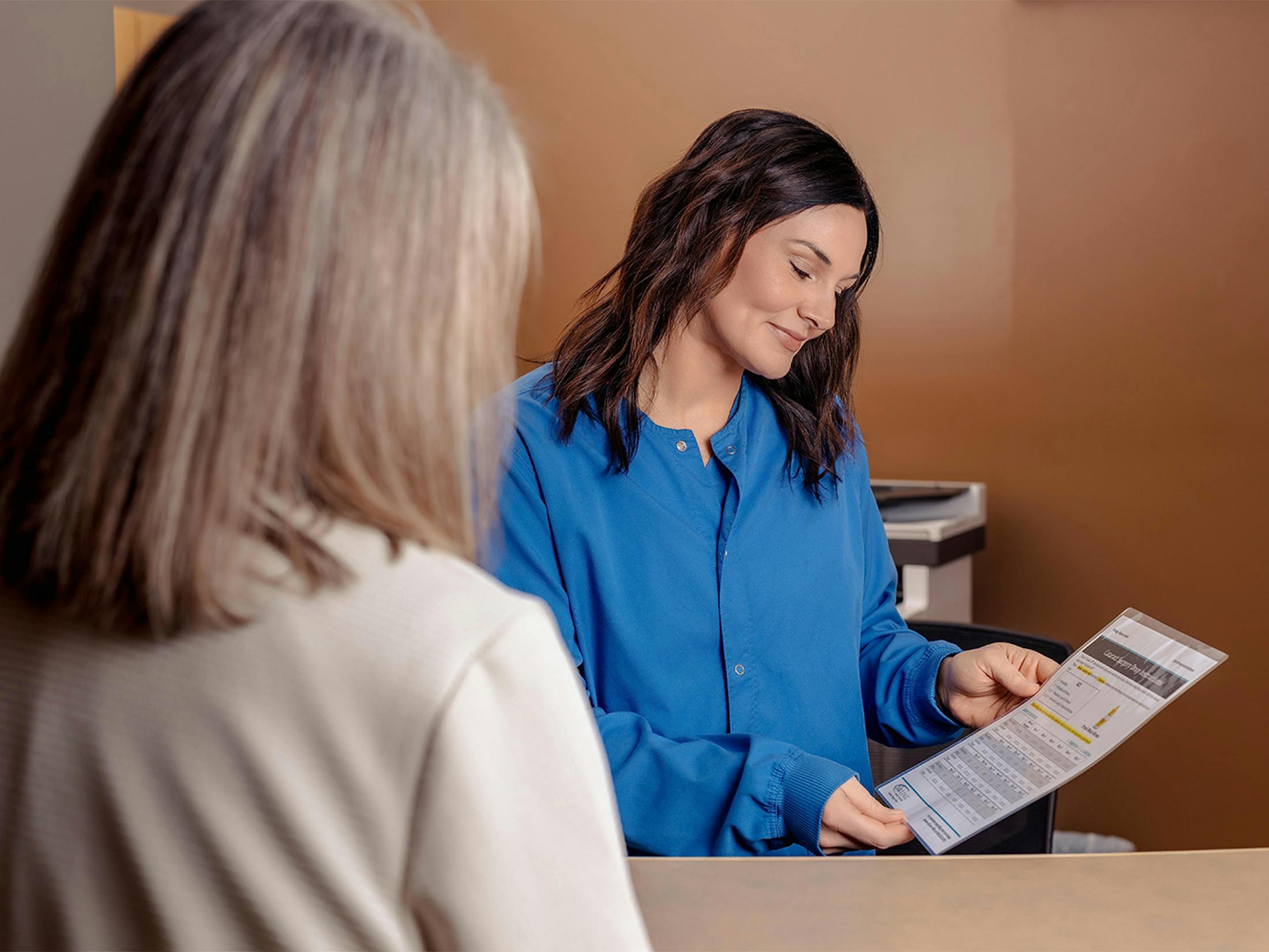 two women looking at a chart