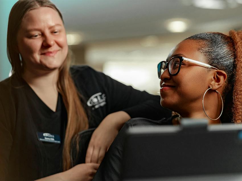 two women smiling at each other