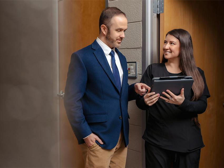 man pointing at a tablet