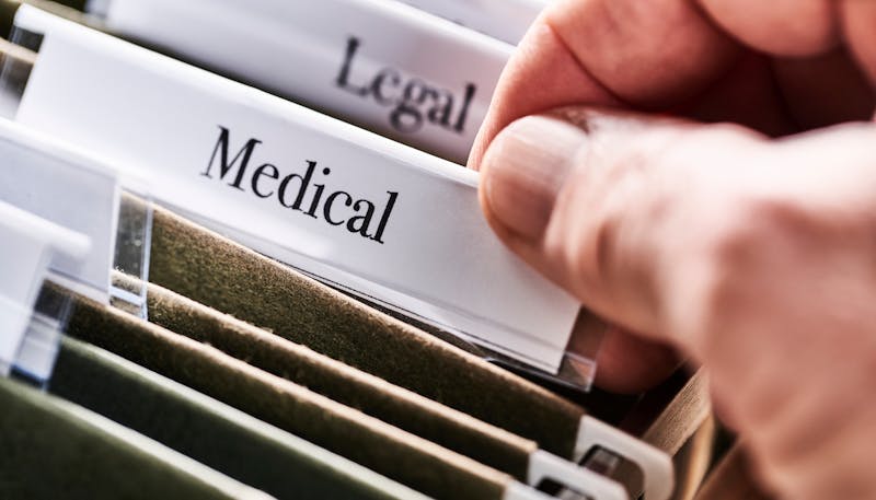 Files and folders in desk drawer with labels and tabs