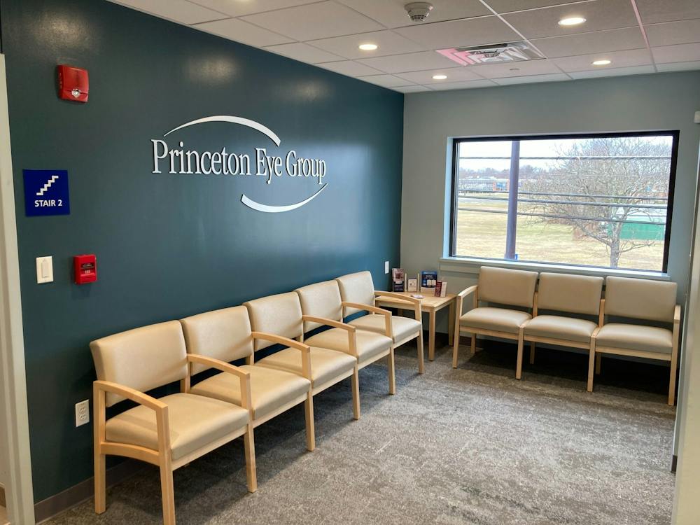Small patient waiting area with chairs and Princeton Eye Group wall sign in the Somerset office