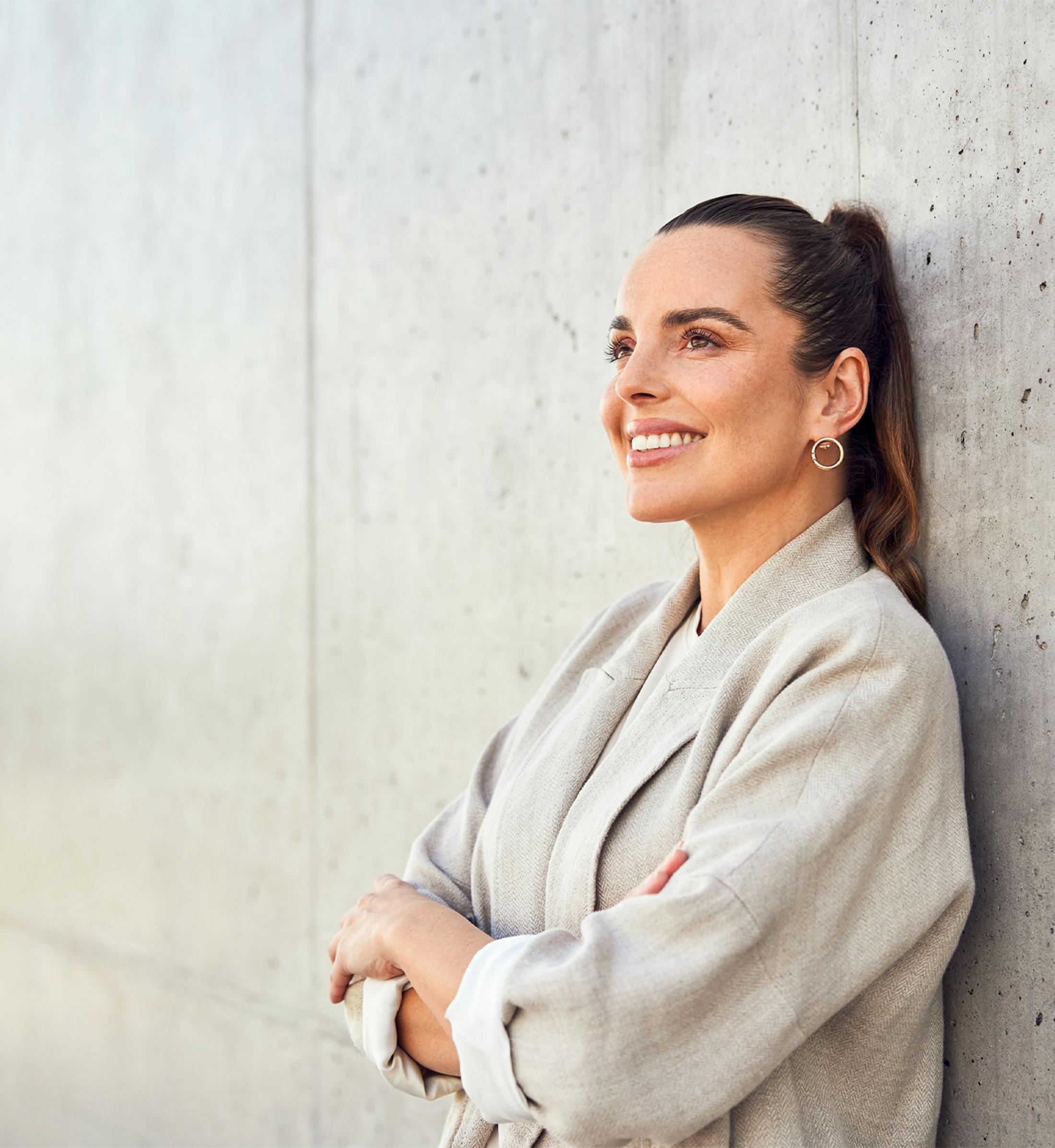 woman leaning against a wall