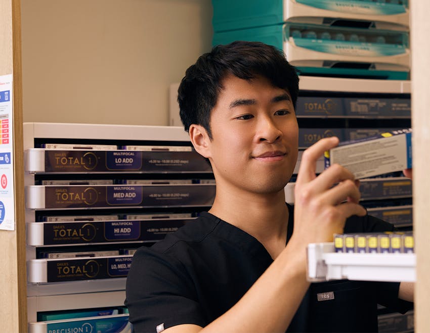 doctor looking at a box of contact lenses
