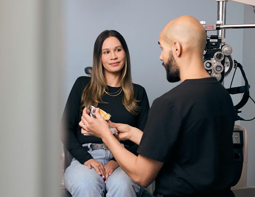 doctor showing a patient an eye model