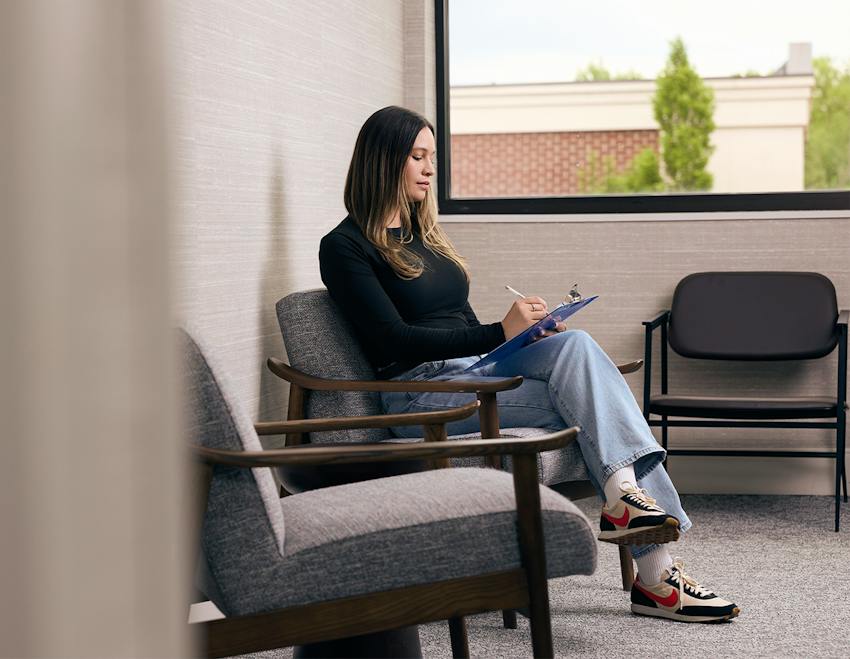 woman sitting and filling out a form