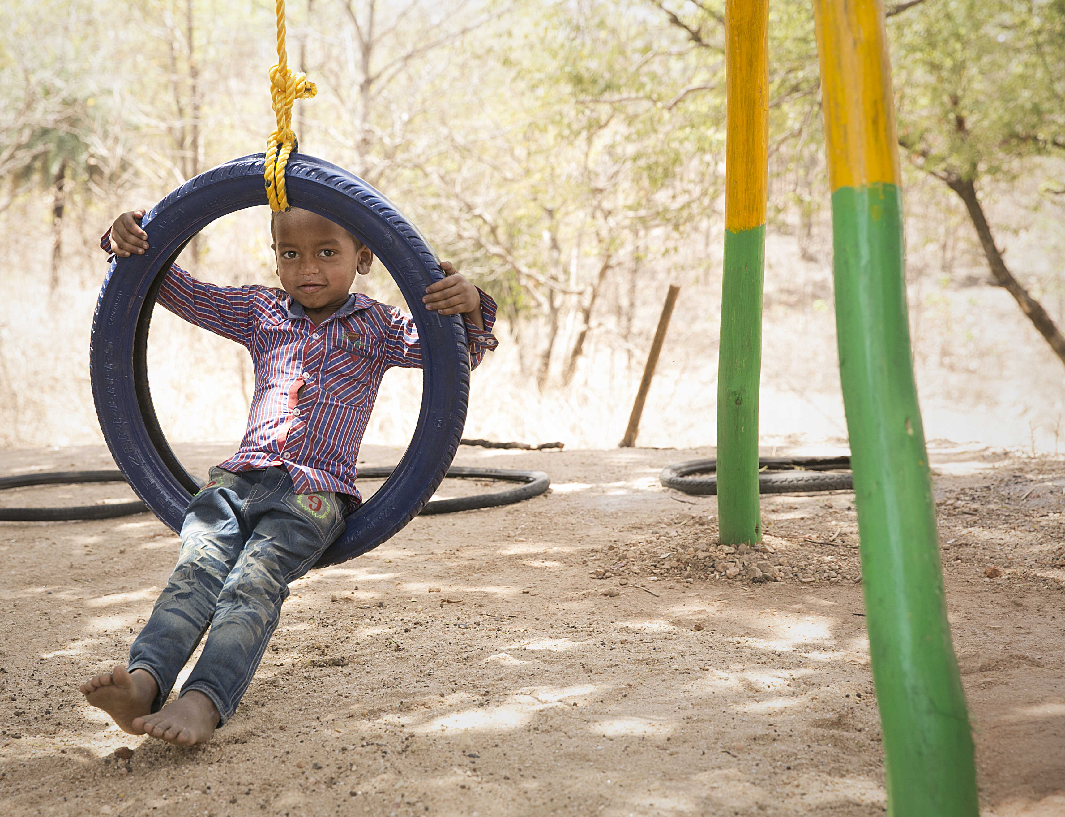 Boy in swing smiling