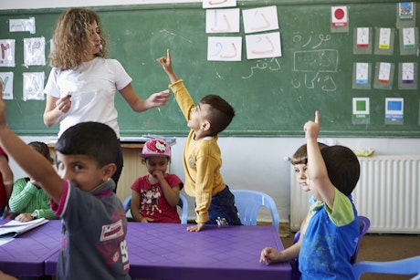 Schoolteacher and children in class