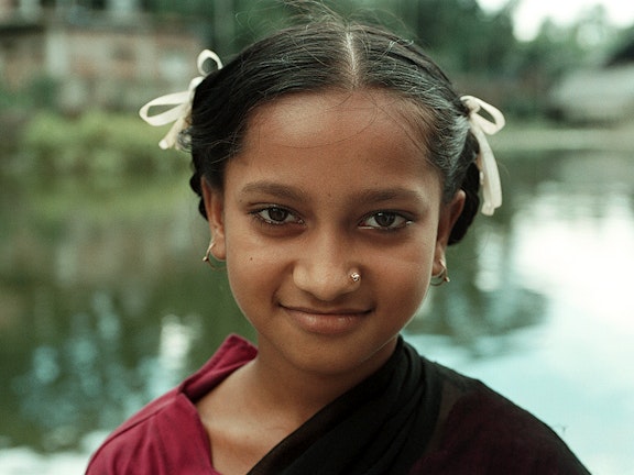 Young girl in Bangladesh looiking directly into the camera and smiling