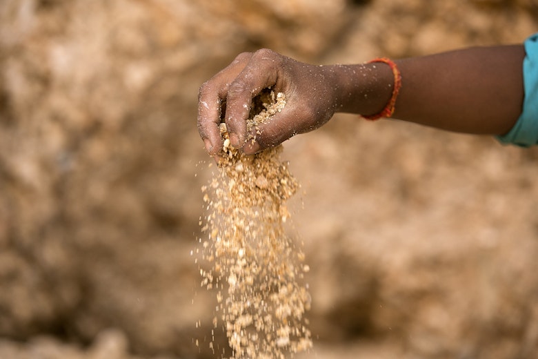 A hand filled with dust and Mica