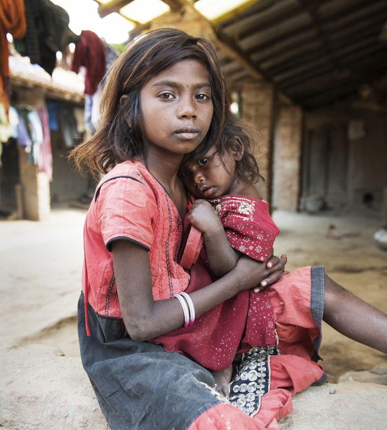 Young girl holding a young child