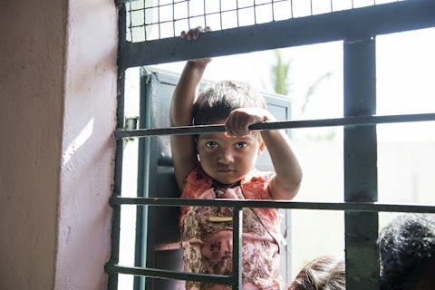 Child waiting outside a window