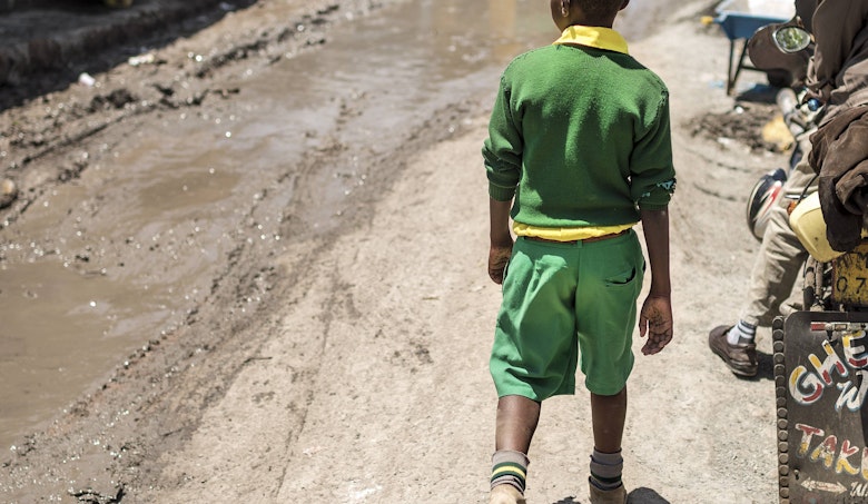 A boy walking on the street in Nairobi