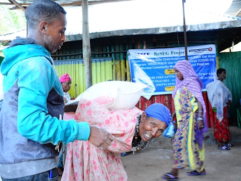 A mother carries the COVID-19 food supply home in Bahir Dar, Ethiopia
