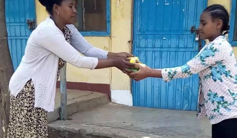 A pupil receives hygiene items to help prevent COVID-19 in Amhara Region, Ethiopia
