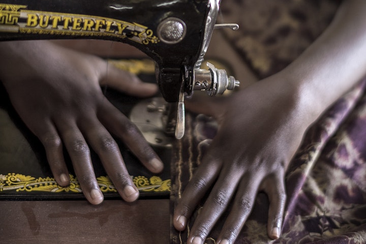 Tanzanian girl sewing