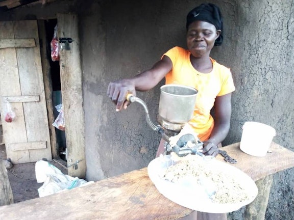 Esther demonstrates her groundnut grinding machine