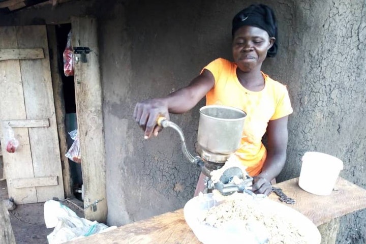 Esther demonstrates her groundnut grinding machine