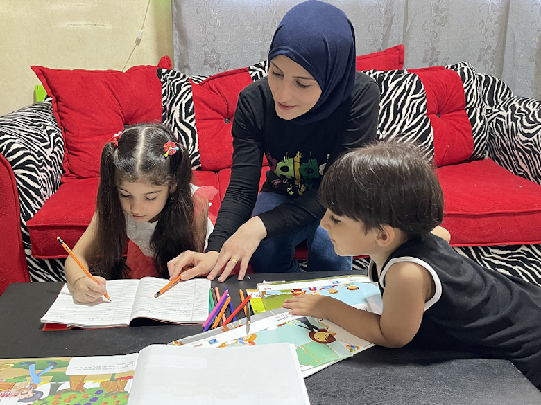 Noha doing school work with her mother