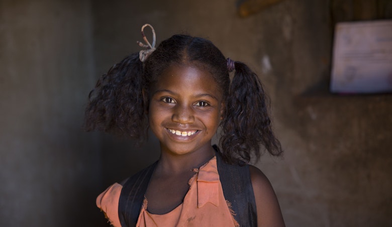 Rosia from Madagaskar no longer works in the mica mines. She enjoys going to school everyday.
