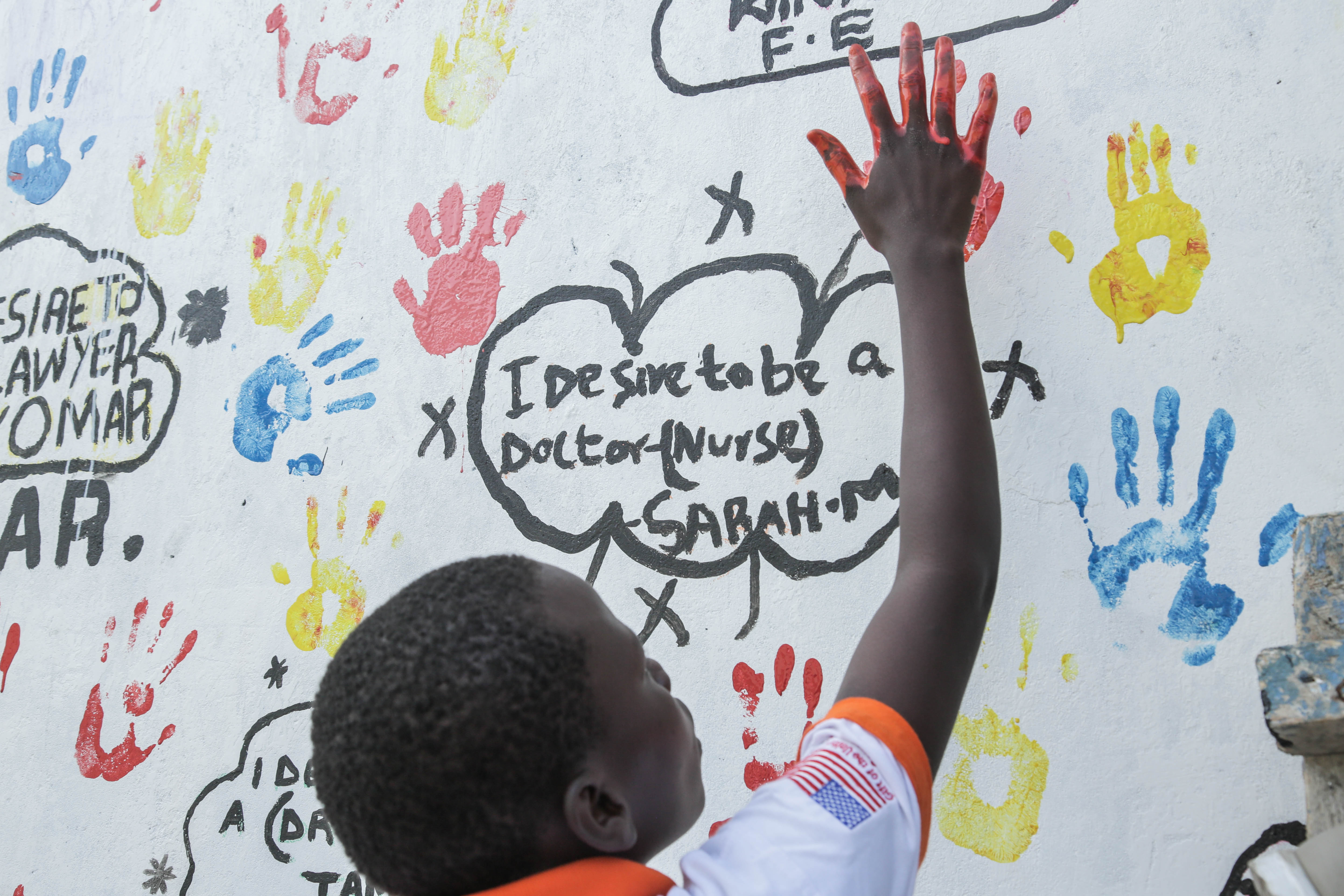 A child painting a mural
