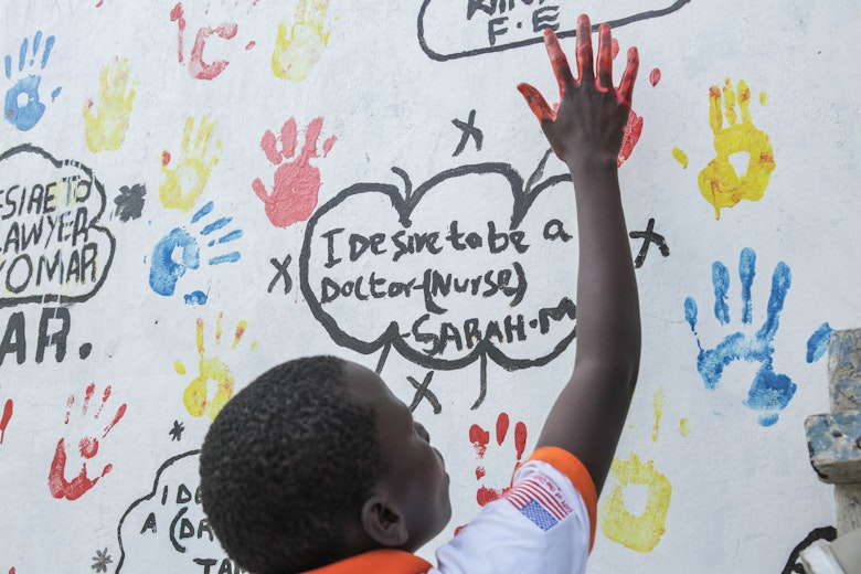 A child painting a mural