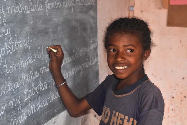 Soanavorie writing on a board in class