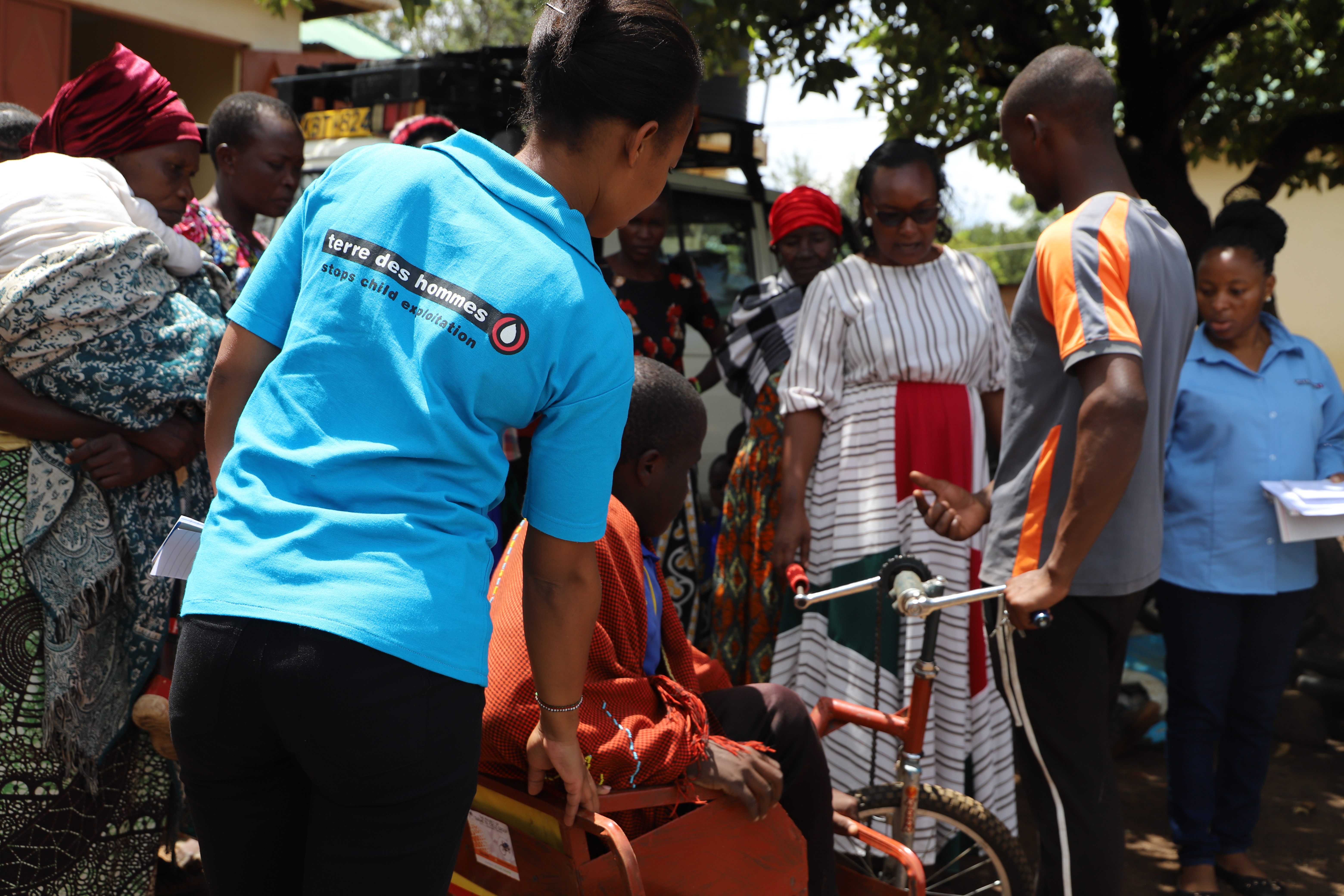 Beneficiary receiving a tricycle