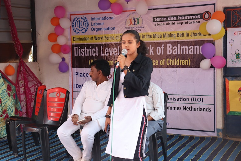 Muskan speaking to a group of children about child labour