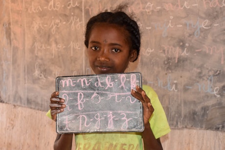 Mary holding her board in class