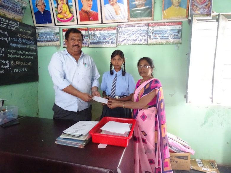Nandini with her school teacher and a project staff
