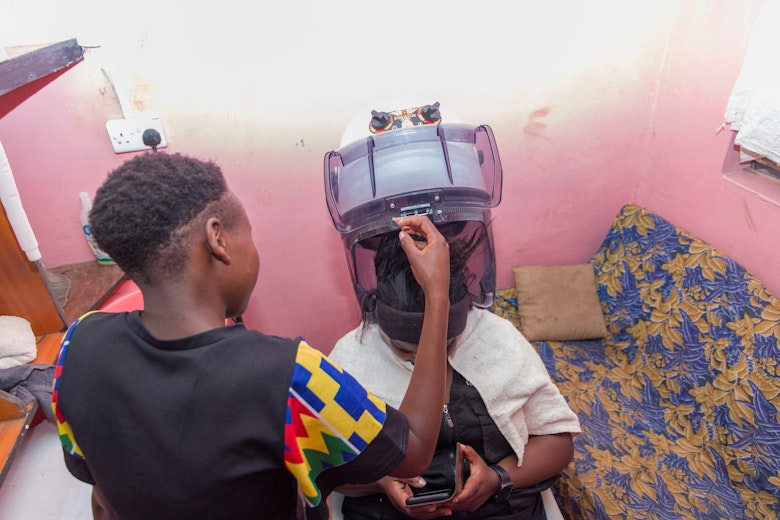 Abigail* setting up a hair dryer in her startup salon