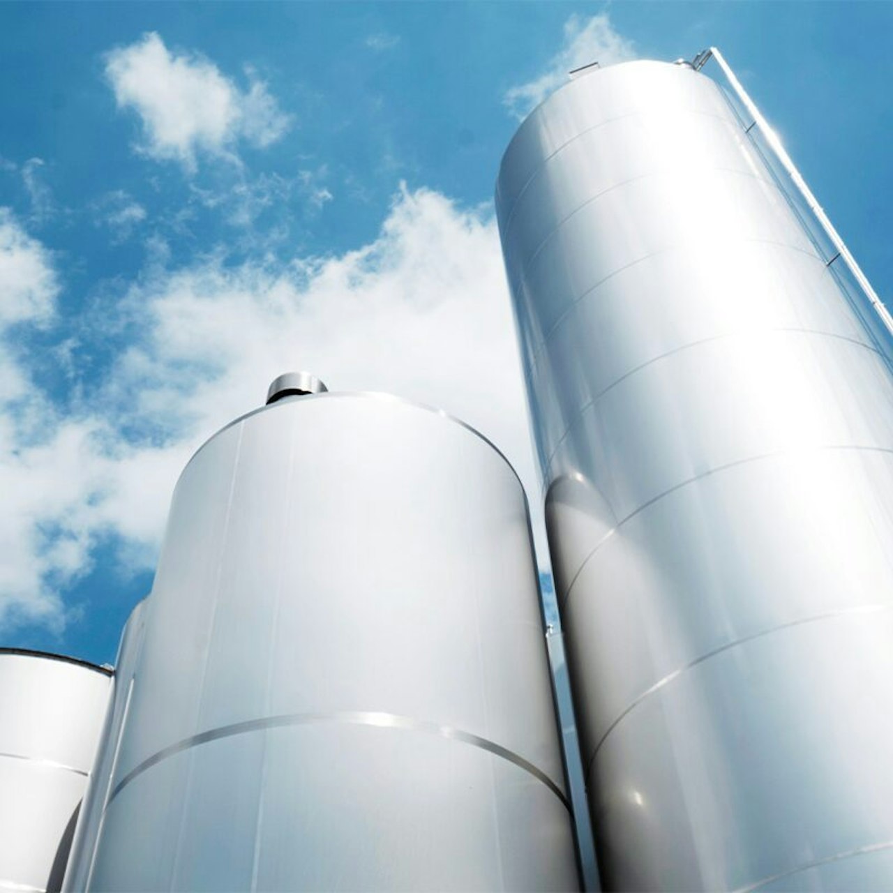 Stainless-steel storage silos at a dairy production site