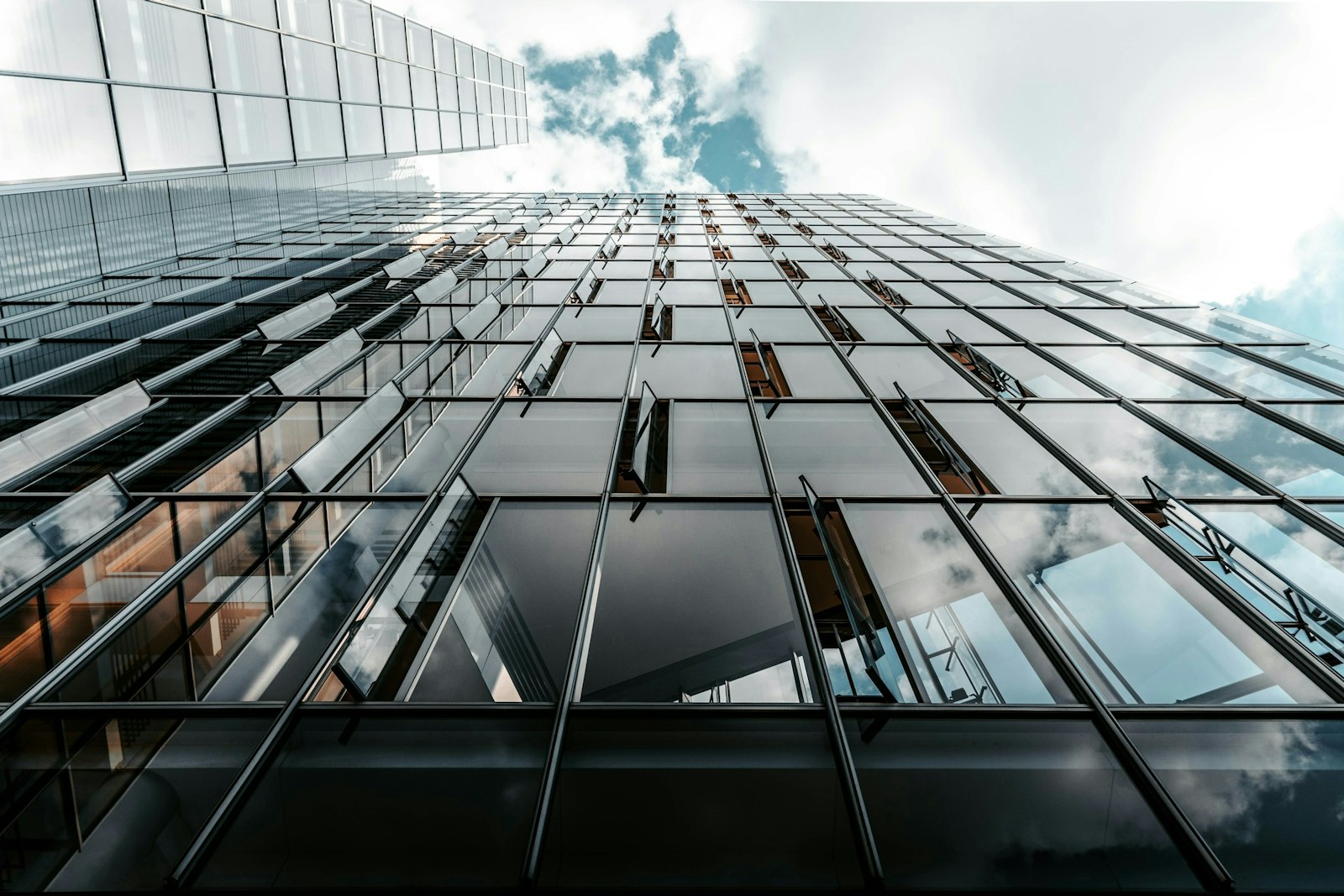 Low angle photo of curtain glass wall building.