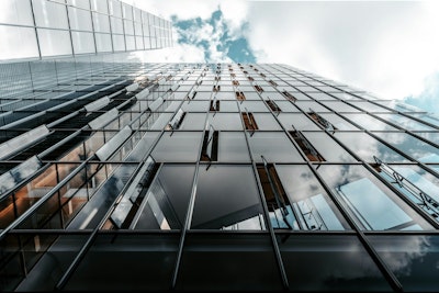 Low angle photo of curtain glass wall building.