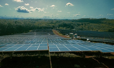 A large solar farm with many rows of solar panels.