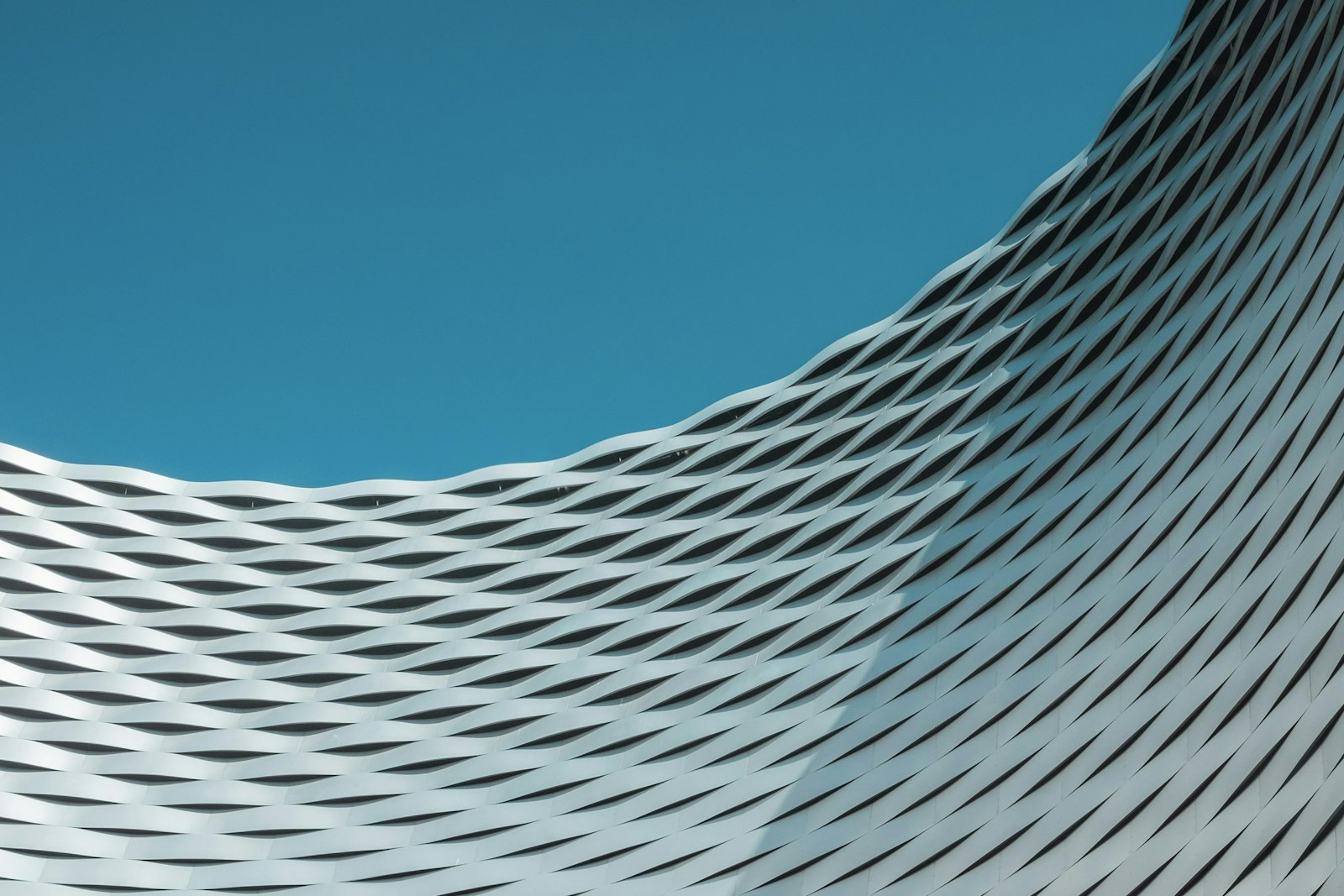 A building with wavy lines on it against a blue sky.