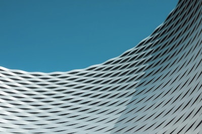 A building with wavy lines on it against a blue sky.